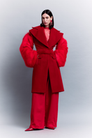Sudi Etuz oversized coat with removable faux fur sleeves, stylish winter outerwear in black, featuring a relaxed fit and cozy design.