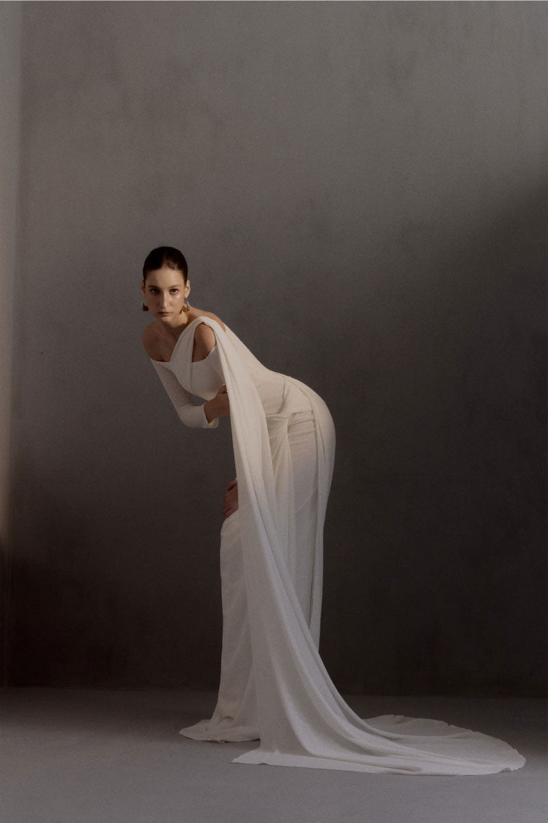 White Plan Narcotic Dress gown with elegant design, featuring a flowing fabric and stylish silhouette.