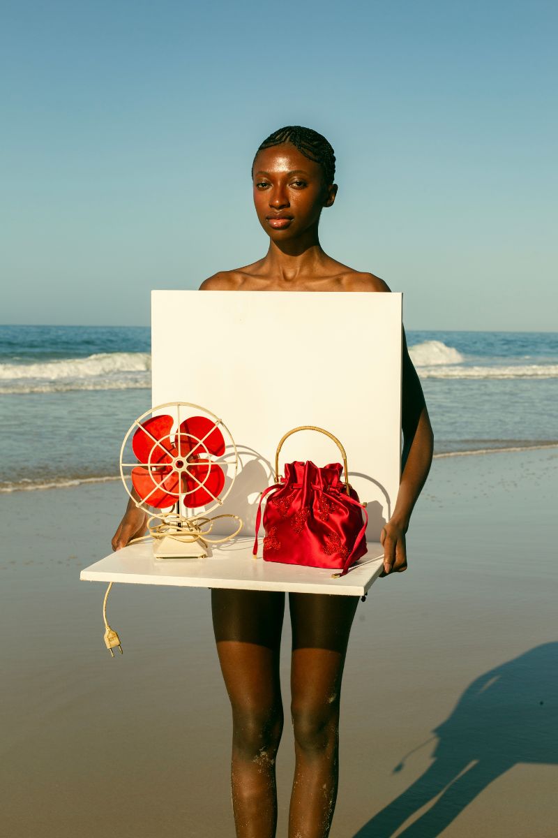 Waiwai Rio BEL CETIM lobster top handle bag in shiny red with gold-tone hardware and structured shape.