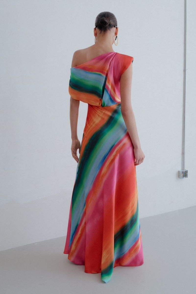 Sisters Nikki maxi dress in Sunset Serenade with flowing fabric and vibrant sunset-inspired colors, displayed on a hanger.
