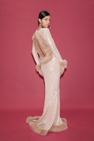 Sudi Etuz sheer sequin gown with faux fur trimmings, elegant evening dress featuring shimmering sequins and plush fur accents.