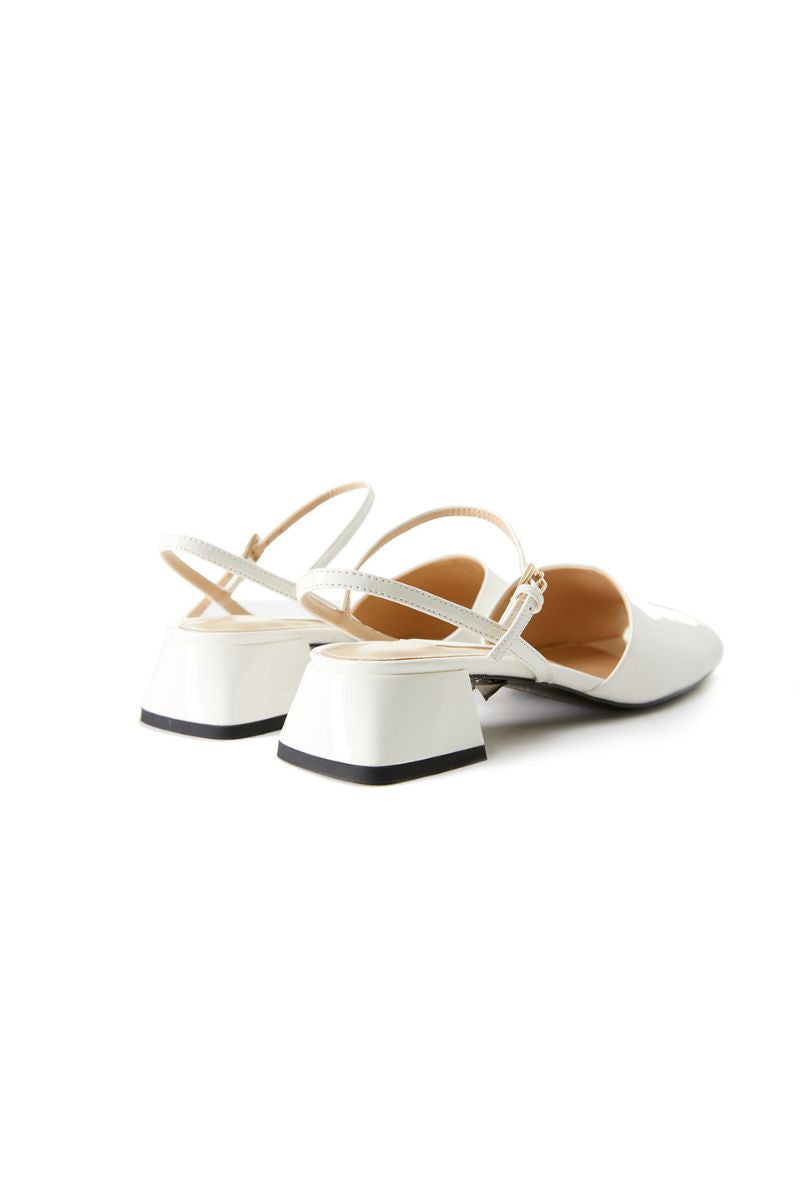 Chictopia ivory peep toe slingback heels on a model showing the stylish sandal design and open toe detail.