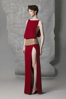 Phan Huy wine-red slit gown featuring a wide back strap, elegant flowy fabric, and stylish design perfect for formal occasions.