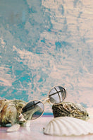 Pearl Osiris sunglasses by Moy Atelier with rounded frames and pearl accents, stylish eyewear on a neutral background.
