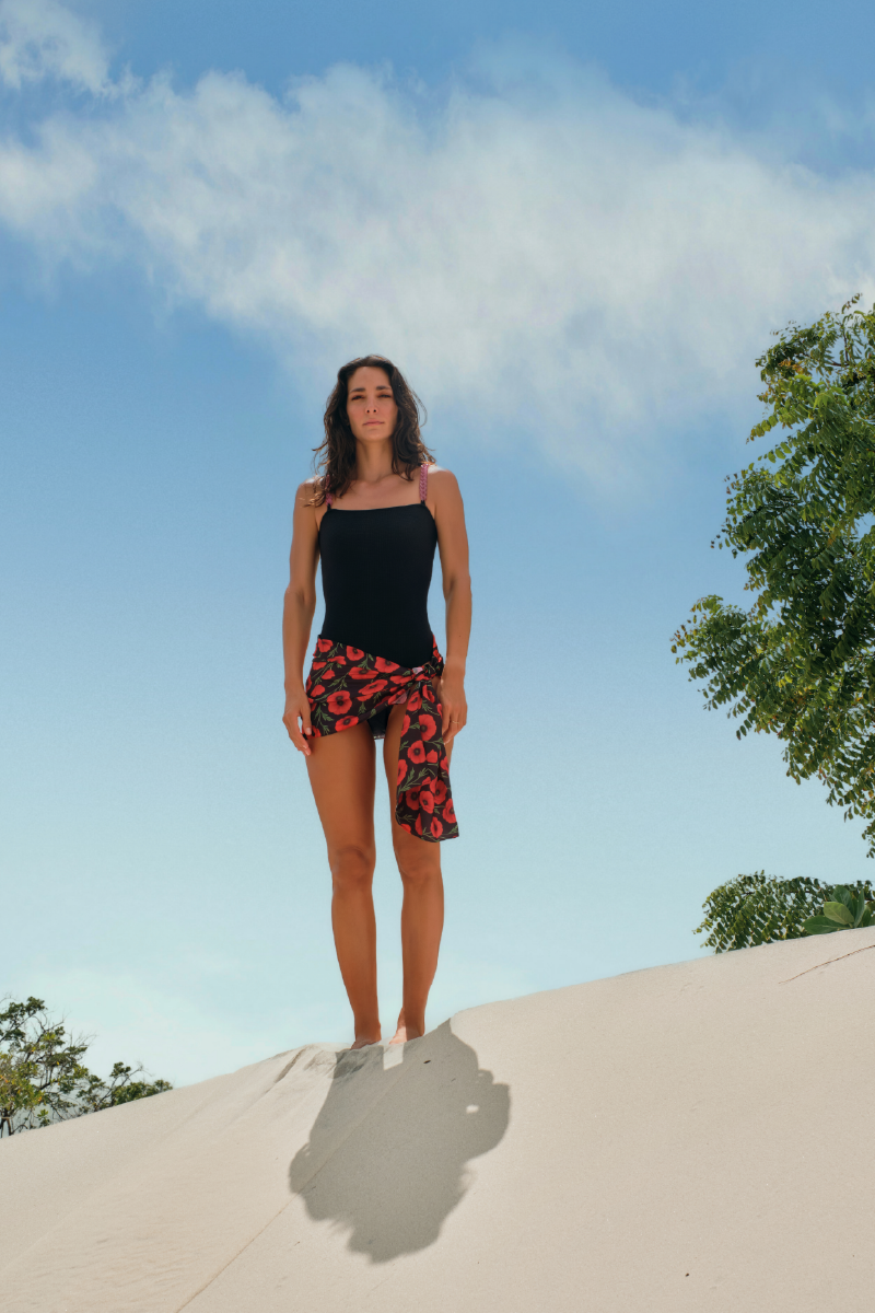 Black Verdelimon Sumatra one-piece swimsuit displayed on a model, showcasing its sleek fit and stylish design.