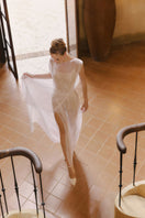 Elegant Bellona dress by Arti Apparel, featuring a flowing gown design with intricate details and a stylish neckline.