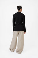 Dāl the Label modal rib knit collared cardigan featuring a soft, fitted design with a button-front and ribbed texture.