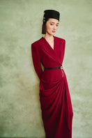 White Plan Crimson Muse gown displaying elegant red fabric and flowing silhouette, perfect for formal occasions.