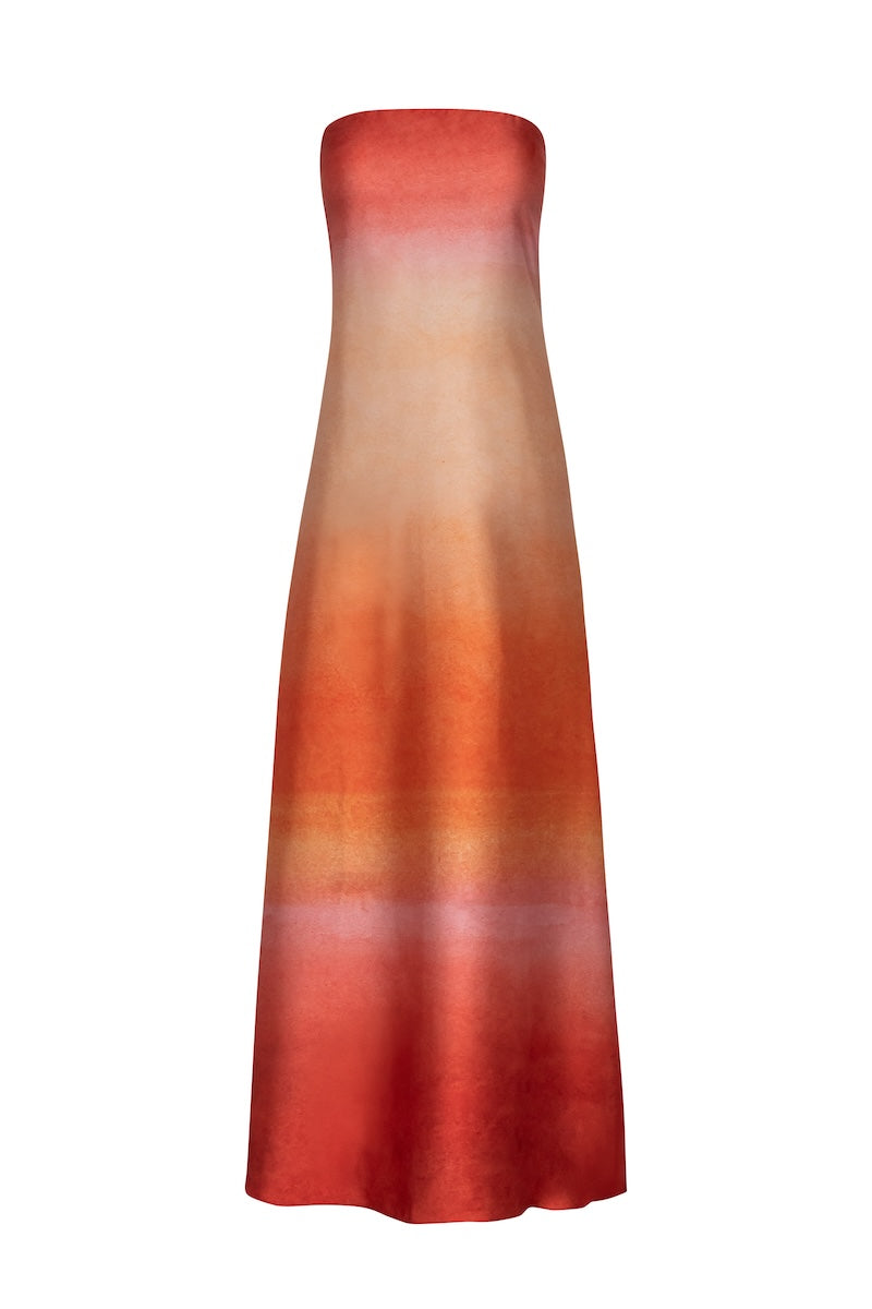 Baobab Lola Maxi Dress shown at sunset, featuring a flowing silhouette, vibrant patterns, and elegant neckline.