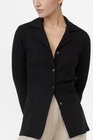 Dāl the Label modal rib knit collared cardigan displayed on a hanger, featuring a soft texture and button closure.