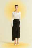Black silk midi skirt by EEGEN STUDIO, showcasing smooth fabric and elegant length in a stylish, flowing design.