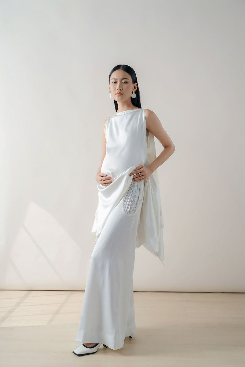 White silk tunic set featuring a midi dress style by DOC BAN, displayed on a hanger with elegant, flowing fabric.