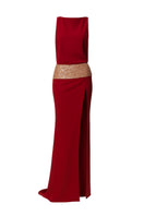 Wine-red slit gown by Phan Huy featuring a wide back strap and elegant flowing fabric.