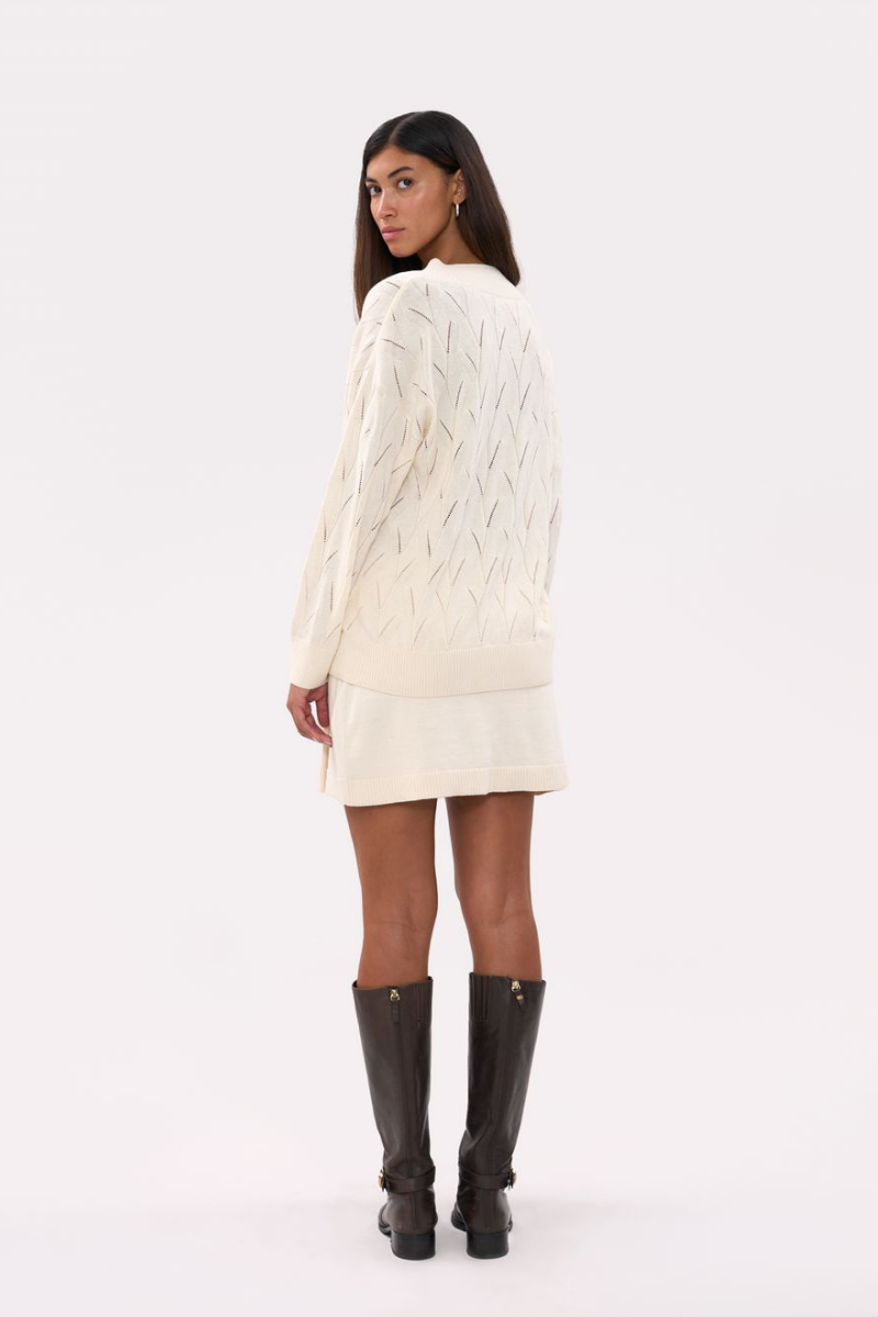Cream oversized V-neck jumper sweater by La Granni, featuring a relaxed fit and soft knit fabric, styled on a model.