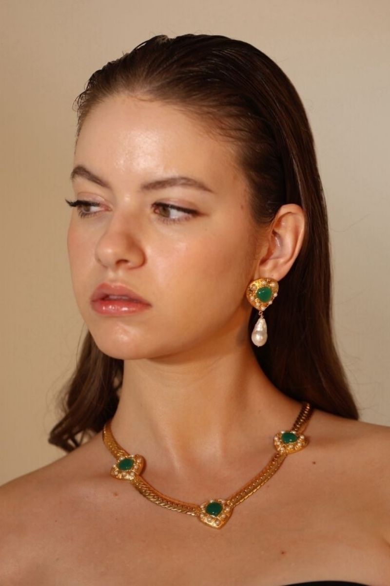 Elegant ANATINA Claudia necklace featuring a delicate chain and stylish pendant displayed on a neutral background.