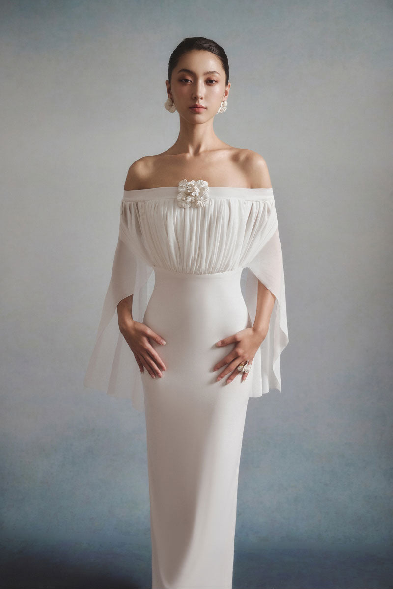 White Plan Elara off-shoulder maxi dress featuring a flowing silhouette and elegant design, perfect for summer or special occasions.