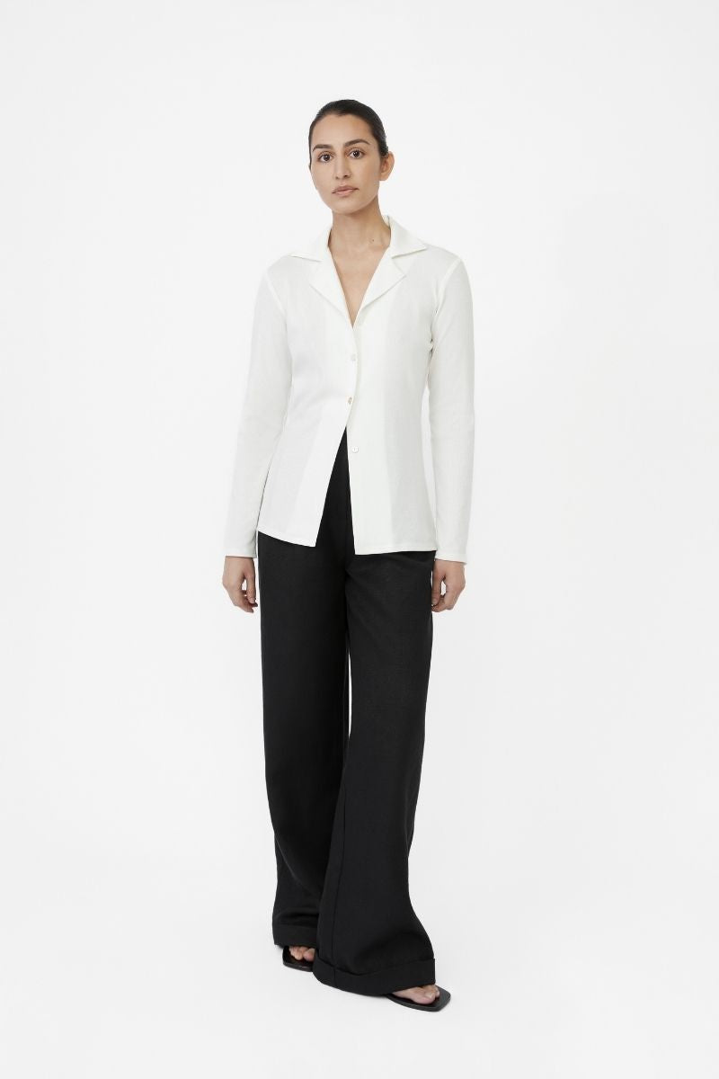 Dāl the Label modal rib knit collared cardigan displayed flat, showcasing its soft fabric, ribbed texture, and classic collar design.