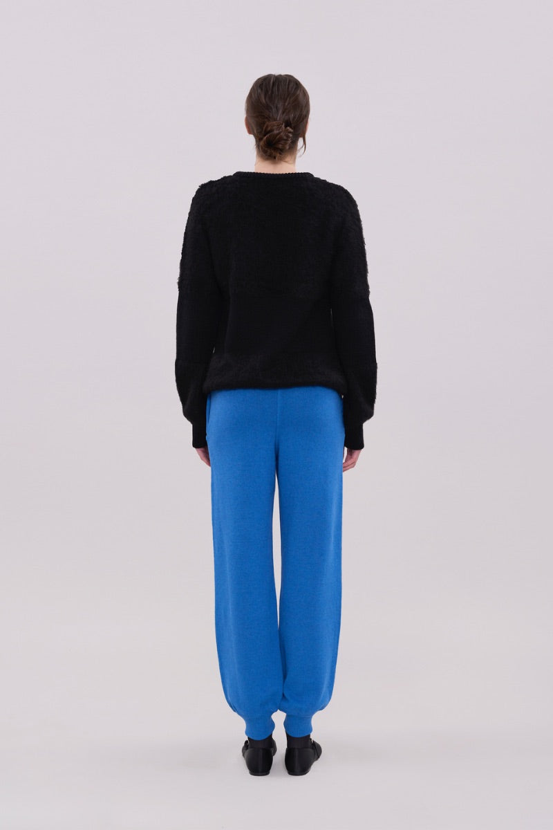 Black two-tone crewneck sweater by La Granni, featuring a stylish design and comfortable fit in a close-up image.