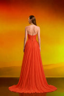 Red crystal chiffon gown by CEM featuring flowing fabric and elegant design, showcased on a model.