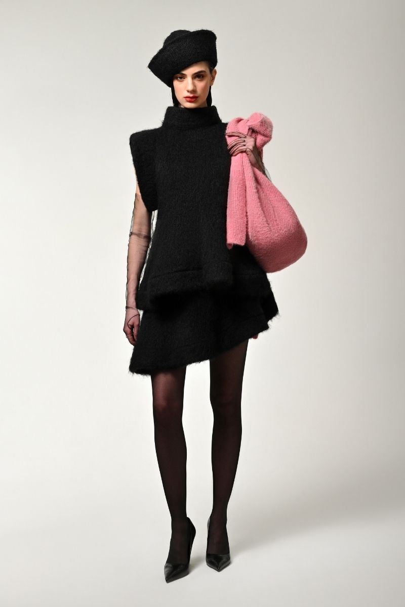 Black knitted mini skirt by Lalo, close-up of the textured fabric and fitted waistband, perfect for casual or stylish outfits.
