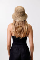 Le SH KA Straw Bucket Hat VOL2 showing a wide-brimmed straw hat with a textured band, perfect for casual summer style.