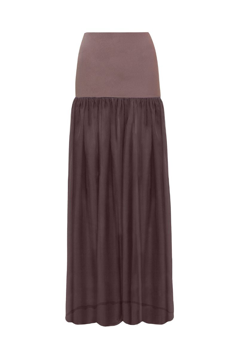 Brown Delfina maxi skirt by Laura Escobar, flowing design with a relaxed fit, shown on a model.