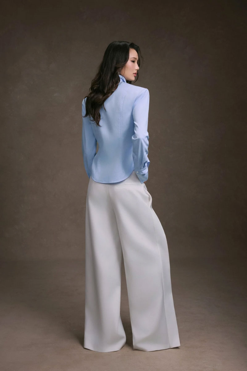Keira Tong striped cupped collar shirt with long sleeves and button front, shown hanging on a hanger.