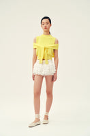Yellow Martha vest by Chictopia, a stylish sleeveless top with a fitted design and vibrant color, shown on a model.