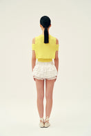 Yellow Martha vest by Chictopia, a stylish sleeveless top with a fitted design, displayed on a mannequin.