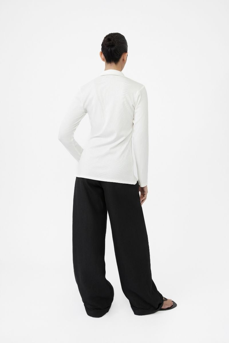Dāl the Label modal rib knit collared cardigan with button closure, featuring a soft, textured knit fabric and a classic collar design.