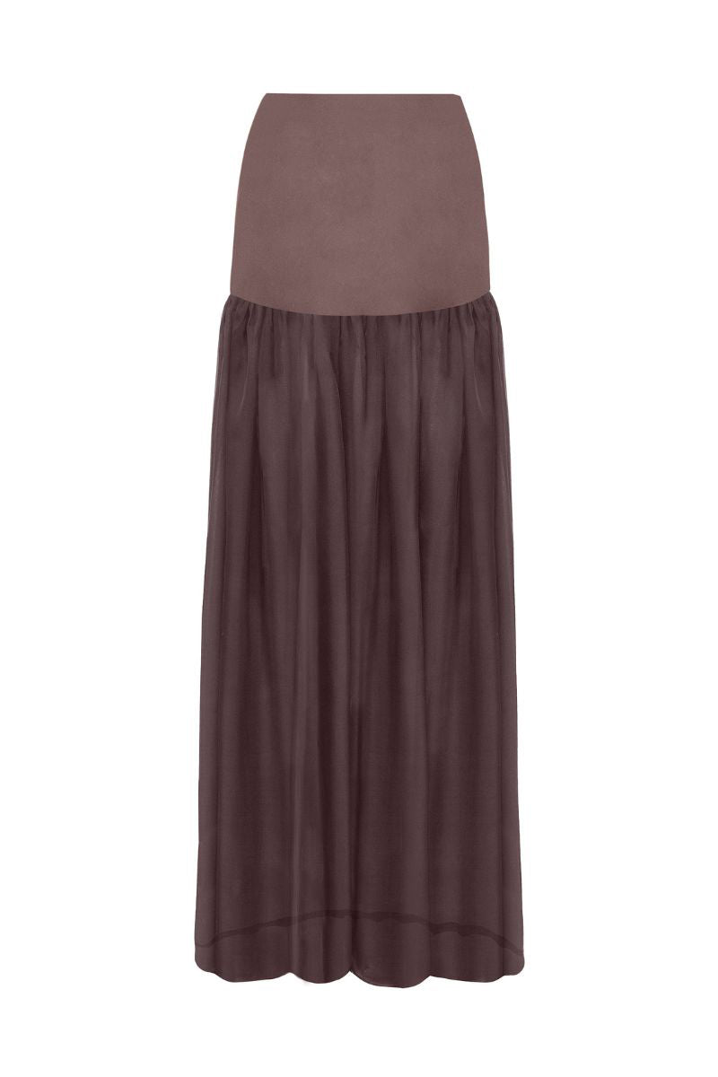 Brown Delfina maxi skirt by Laura Escobar, shown with flowing fabric and a high waist design in a stylish, elegant silhouette.