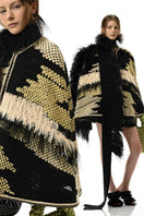 Lalo Avril Cape in multicolor, stylish jacket with vibrant patterns, shown on a hanger, perfect for layered fall or spring outfits.