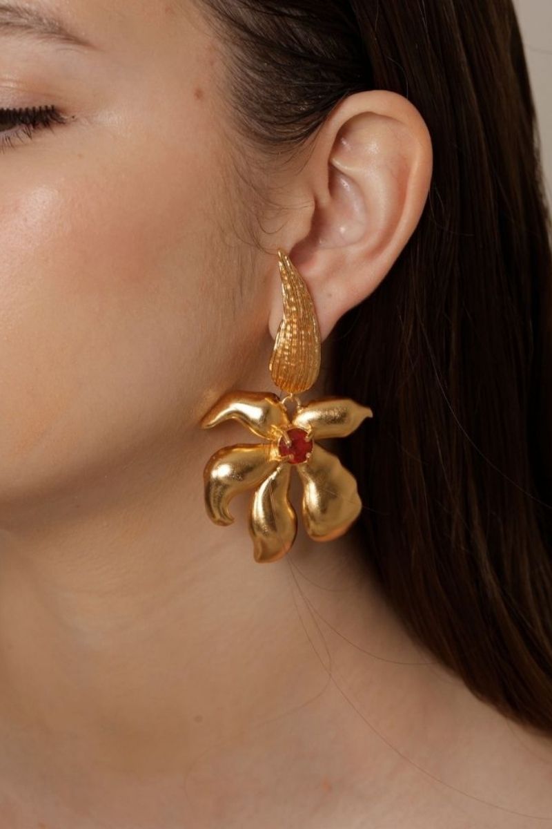 Gold Fiona Fire earrings by ANATINA featuring fiery, flame-shaped design in polished metal for a bold, stylish look.