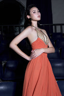 Red crystal chiffon gown by CEM featuring a flowing design with sparkling embellishments and elegant draping.