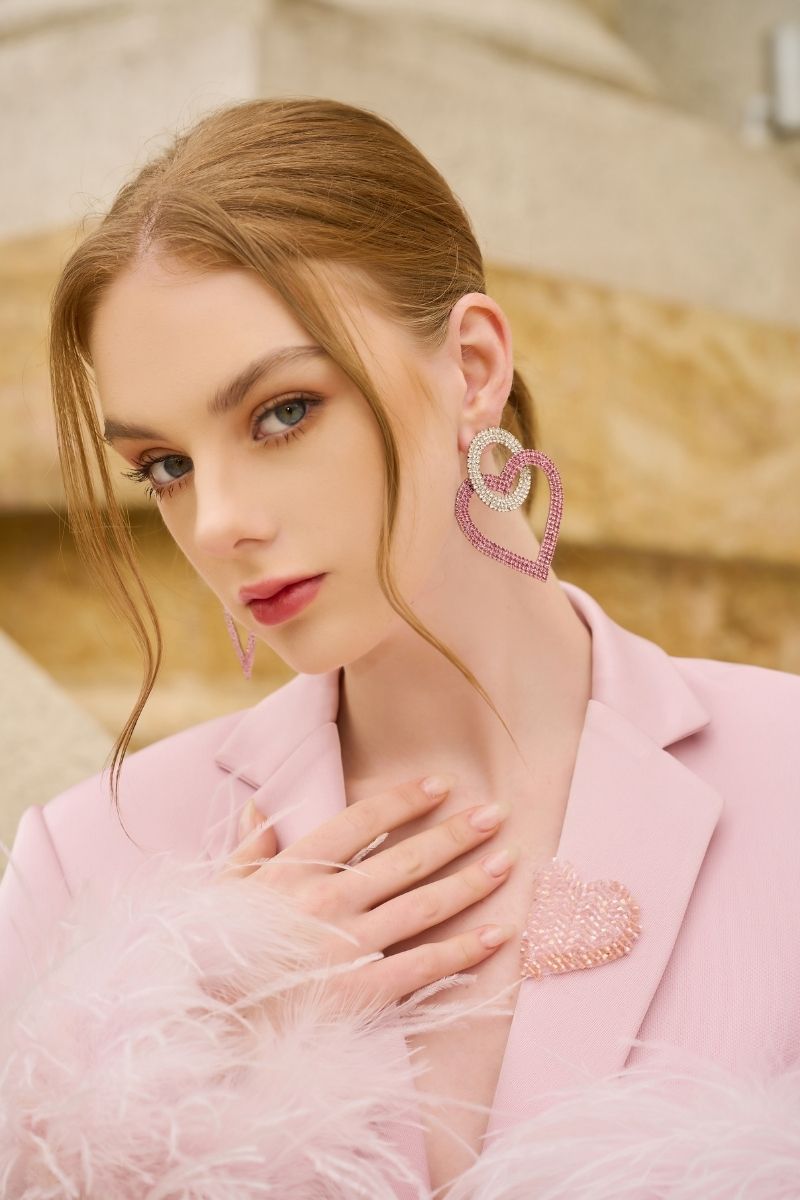 Baby pink Kelly taffeta feather suit co-ords by 21Six, featuring a jacket and pants set with feather details.