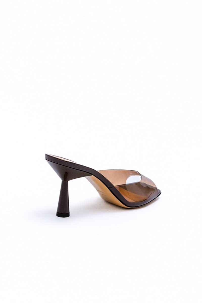 Kolane Greta mule sandals in chocolate brown with transparent straps, showcasing stylish open-toe design and slip-on style.