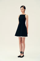 Black Linda mini dress by Chictopia, featuring a stylish fit and elegant design, shown on a model.