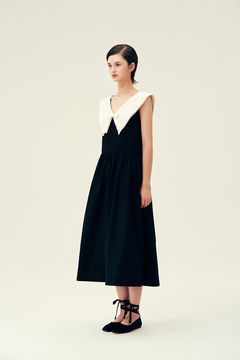 Black Sydney midi dress by Chictopia, stylish and elegant, shown on a model with a fitted silhouette and flowing fabric.