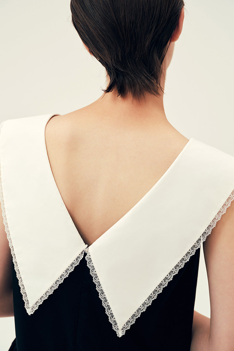 Chictopia Sydney black midi dress displayed on a hanger, showcasing its elegant design and fabric details.