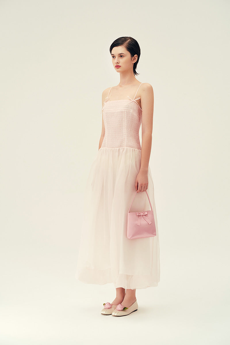 Light pink Cynthia maxi dress by Chictopia displayed on a hanger, showcasing flowing fabric and elegant design.