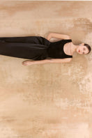 Long black Laurent maxi skirt by Arti Apparel with flowing fabric and high waist, shown on a model.