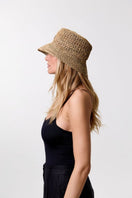 LE SH KA straw bucket hat from Vol2 collection, featuring a wide brim and woven straw texture, perfect for sun protection.