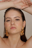 Anatina Fiona Fire earrings featuring vibrant, fiery-colored earrings with intricate design and gold-tone accents.