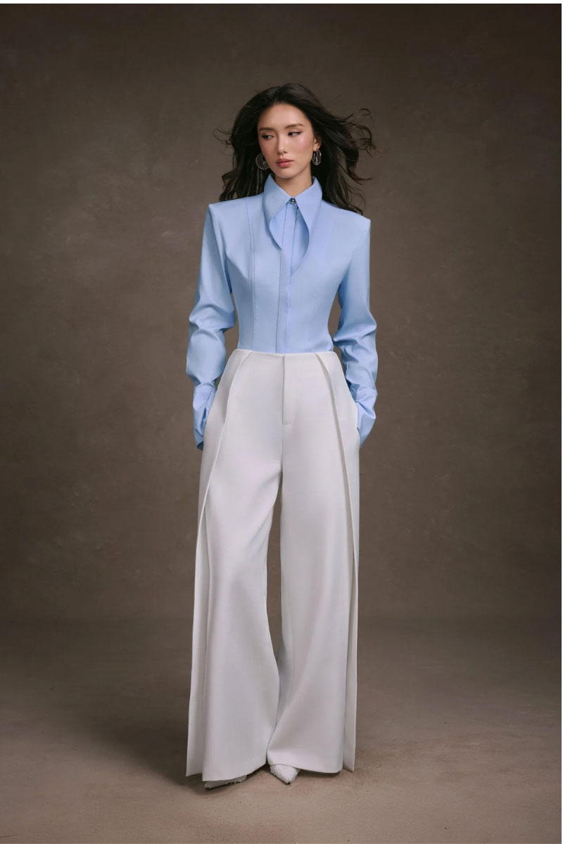 Folded KEIRA TONG layered pants, casual style with multiple fabric layers, displayed on a plain background.