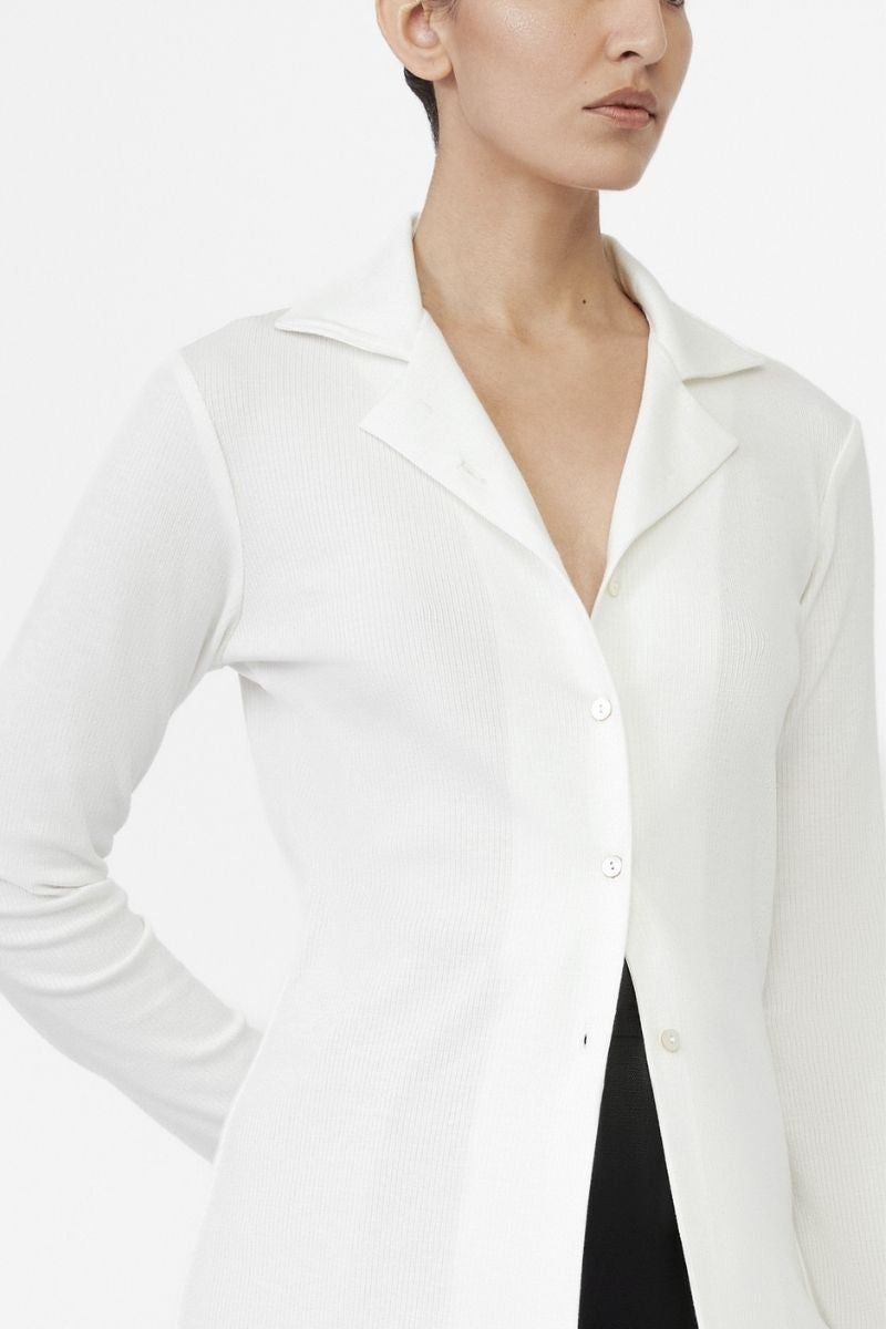 Dāl the Label modal rib knit collared cardigan displayed on a hanger, featuring a button-up front and ribbed texture.