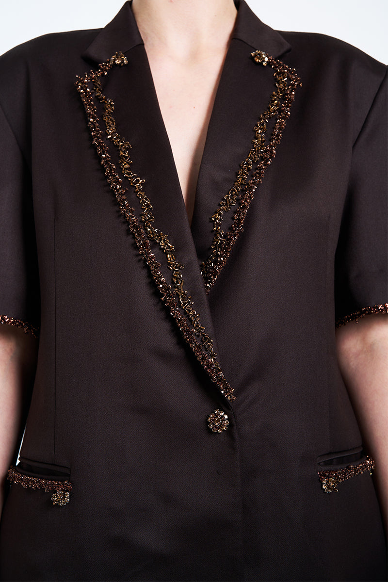 Aidan & Ice NARA brown blazer, tailored fit with lapels and button closure, displayed on a hanger against a neutral background.