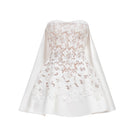 White detachable cape skater mini dress by Montsand, featuring a stylish fit, flowing cape, and trendy design for casual or party wear.