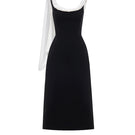 Black Montsand midi dress with a low back and stylish scarf detail, perfect for elegant occasions.