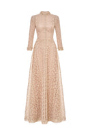 Elegant gold leaf button-front gown by Montsand, featuring a flowing fabric and intricate button details.