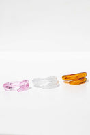 Set of three Salvárea rings in pink, amber, and white Remolino design, showcasing stylish, colorful jewelry.